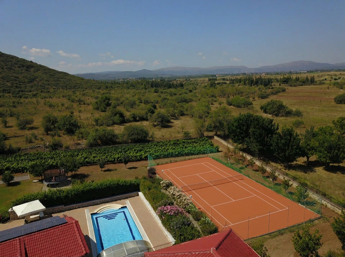 Aerial view from Villa Arcadia over the private tennis court, vineyard and mountain valley