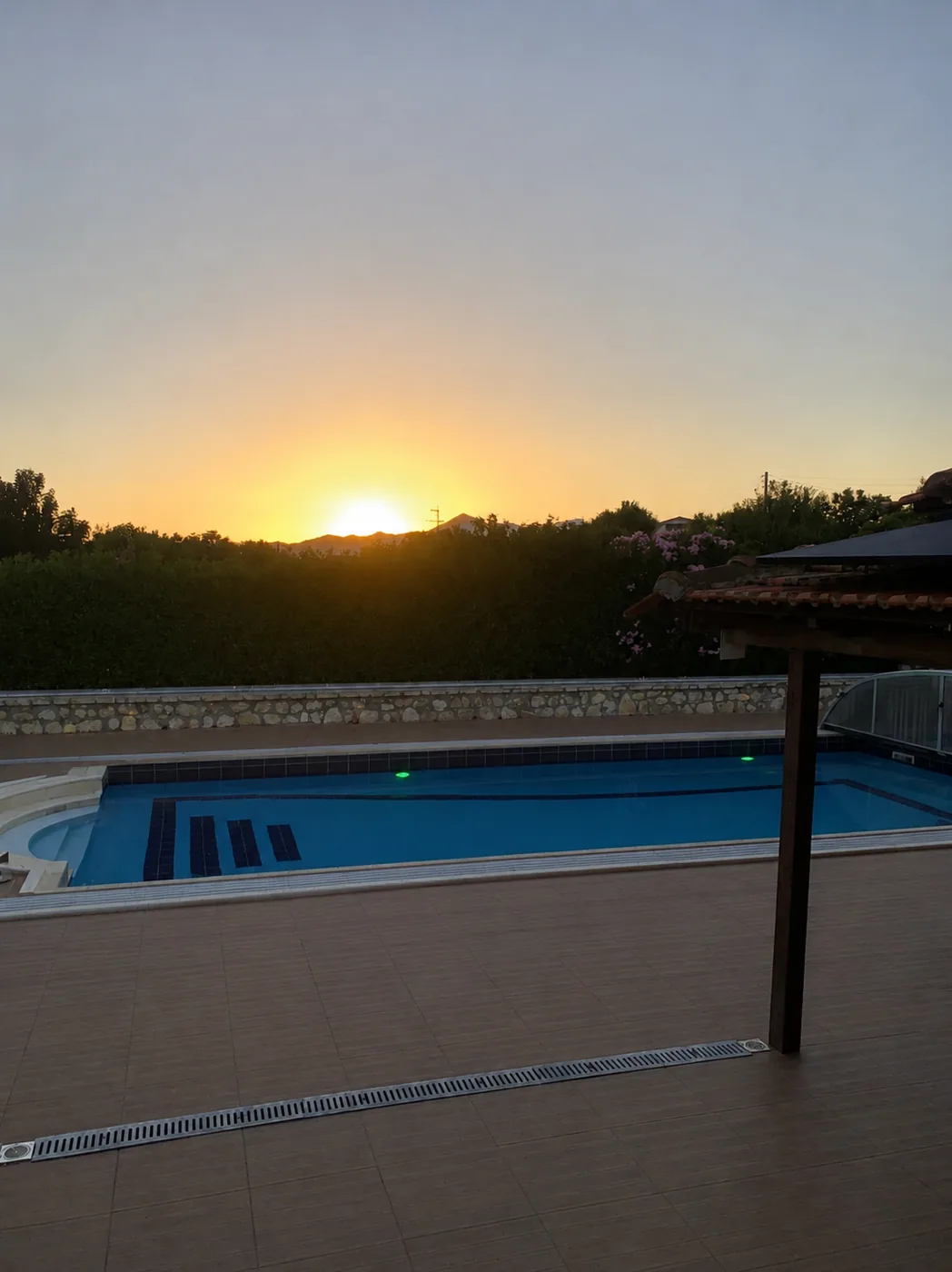 Sun setting behind the hills above the Villa Arcadia pool