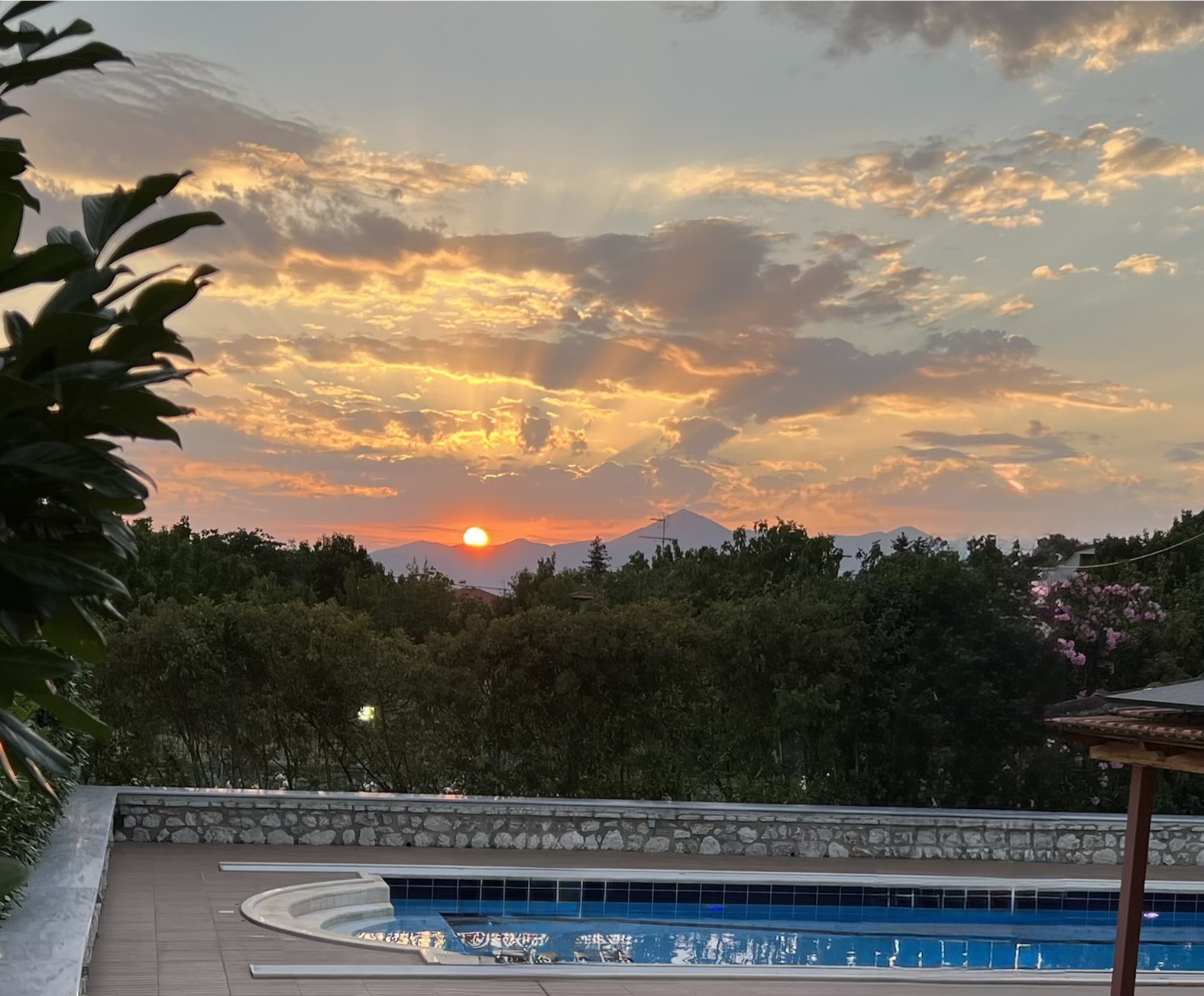 Sunset over the mountains behind the heated pool at Villa Arcadia