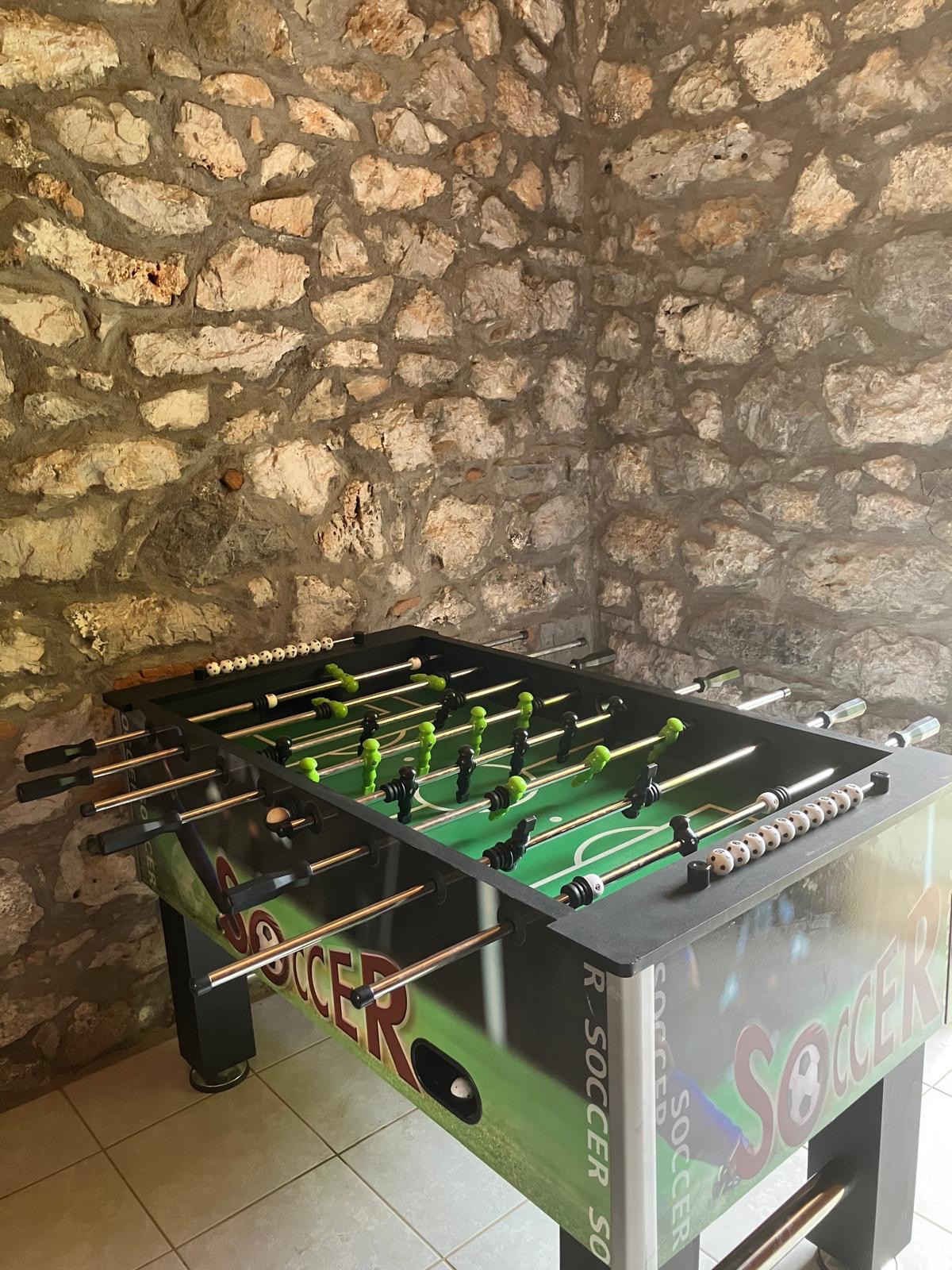 Foosball / futsal table in the stone-walled game room at Villa Arcadia